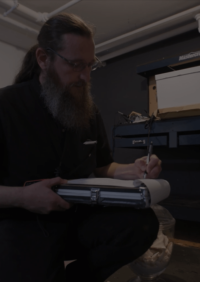A person writing on a paper for an assessment