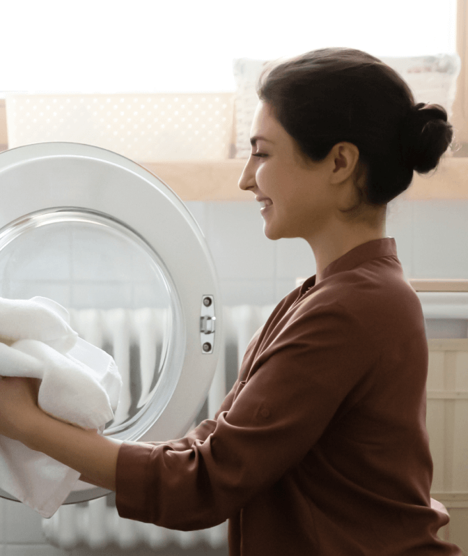 Woman looks inside her fridge.