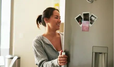 A person empties their dryer